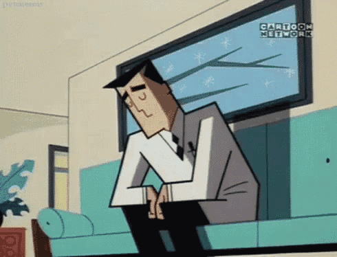 a man in a suit and tie is sitting on a couch looking out a window .