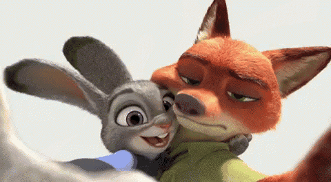 a fox and a rabbit are hugging each other .