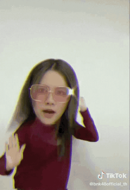 a tiktok video of a woman wearing glasses