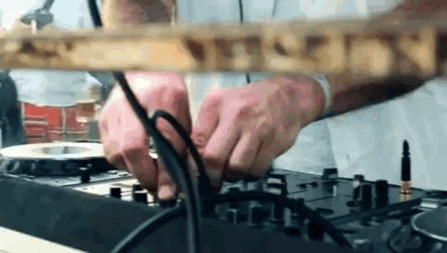 a man is playing music on a mixer .