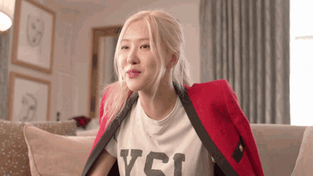a woman wearing a red jacket and a t-shirt that says yci
