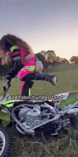 a woman riding a dirt bike with the words and i don 't understand written on the bottom
