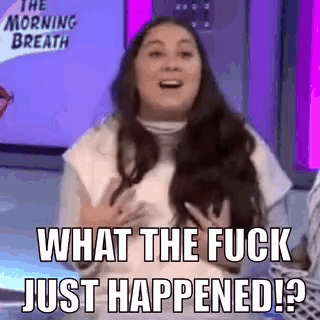 a woman is sitting on a stage and laughing with the words `` what the fuck just happened ? ''