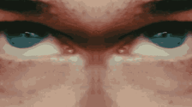 a close up of a person 's eyes that are blue