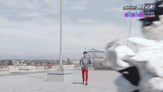 a man is standing on a rooftop with a sign that says ' samurai ' on it