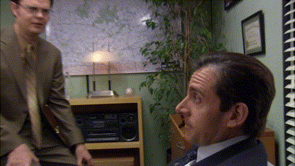 a man in a suit and tie talking to another man