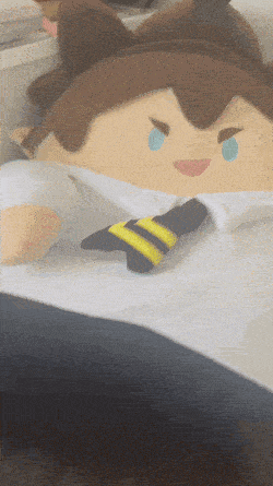 a stuffed cartoon character with a tie and a blue eye