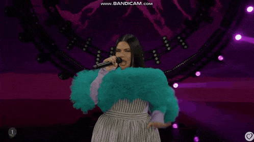 a woman singing into a microphone with the website www.bandicam.com at the bottom of the screen