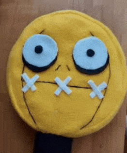 a yellow smiley face with blue eyes and white x 's in its mouth