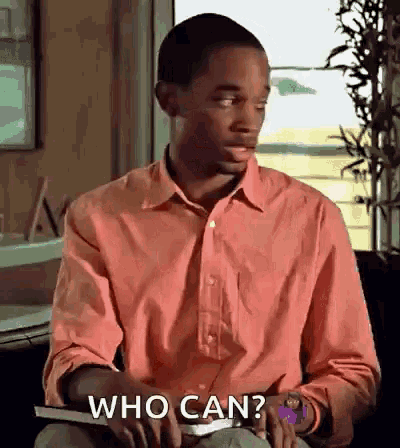 a man in a pink shirt is holding a book and asking " who can "