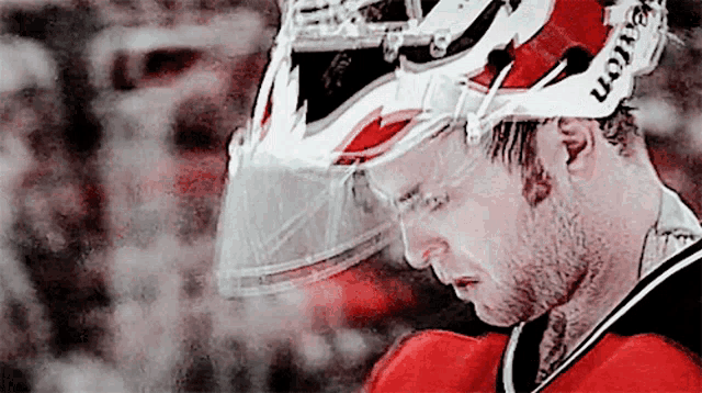 a hockey player wearing a helmet that says ccm