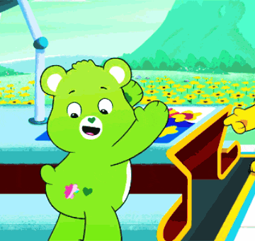 a green teddy bear with a pink heart on its butt