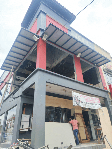 a building under construction with a sign that says ' awas ! ' on it
