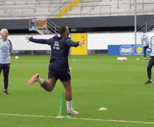 a soccer player with uber eats on the back of his shorts