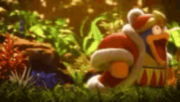 a stuffed animal in a santa hat is standing in the grass .