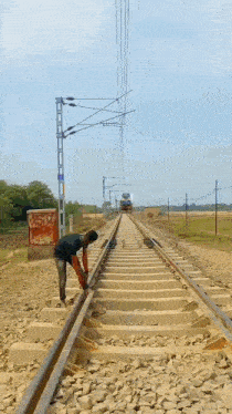 a man is working on a train track near a train
