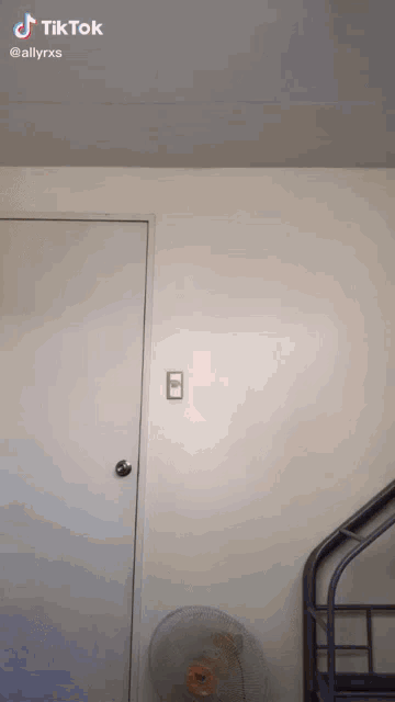 a room with a door and a fan and a tiktok watermark