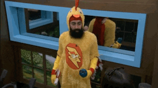 a man in a chicken costume is standing in front of a mirror