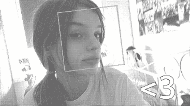 a black and white photo of a girl with a square on her face and the number 3