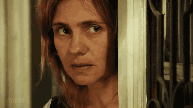 a close up of a woman 's face with voyage written in the lower right corner