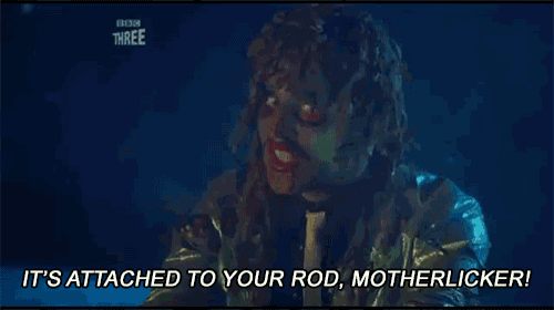 a woman with dreadlocks is holding a rod and says `` it 's attached to your rod , motherlicker ! ''