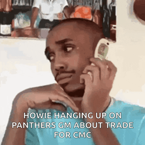 a man is talking on a cell phone and the caption says howie hanging up on panthers gm about trade for cmc