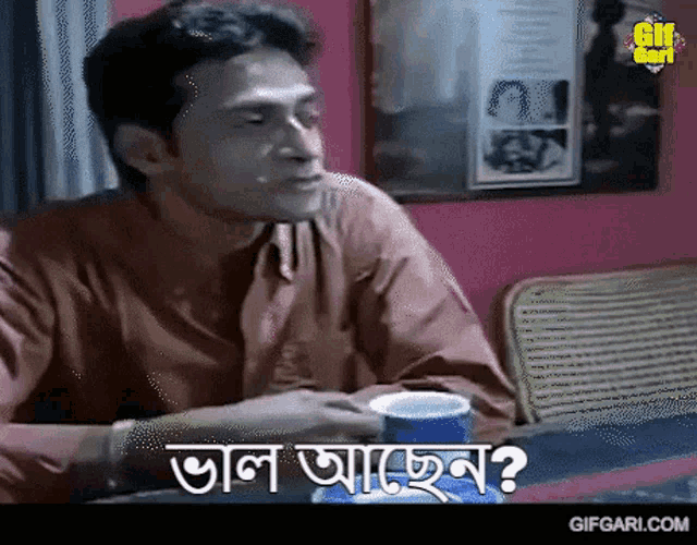 a man is sitting at a table with a cup of coffee and a gif from gifgari.com is above him