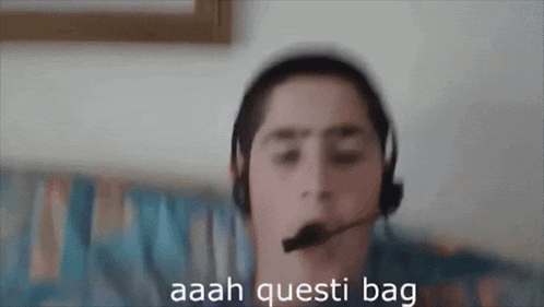 a blurry picture of a man wearing headphones and a microphone with the words aaah questi bag below him