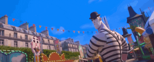 a man in a striped shirt and a hat is pointing at the camera