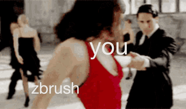 a woman in a red dress is dancing with a man in a black suit and tie