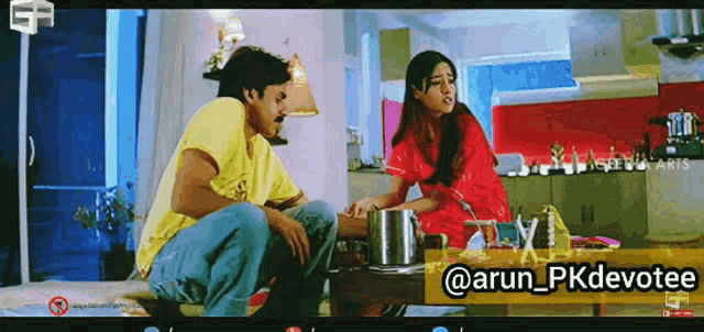 a man in a yellow shirt sits next to a woman in red