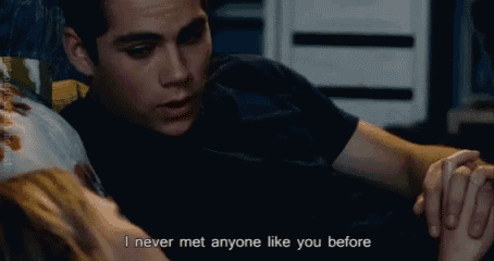 a man laying on a bed holding a woman 's hand with the words " i never met anyone like you before "