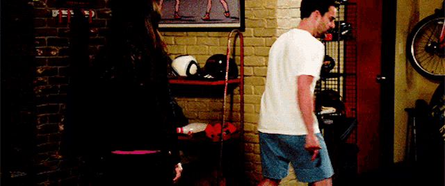 a man and a woman are standing next to each other in a room