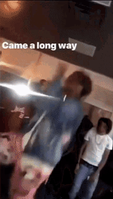 a group of people are dancing in a room with the words came a long way on the bottom