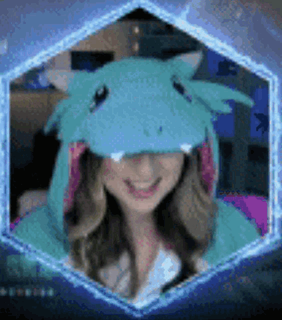 a woman is wearing a blue dragon costume and smiling