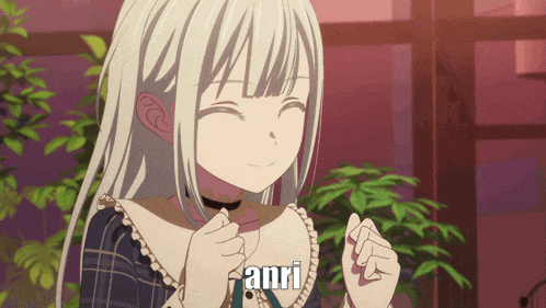 a girl with white hair is smiling with the word anri above her
