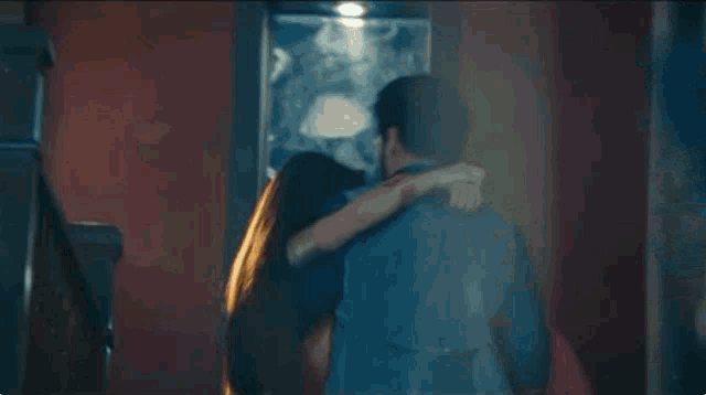 a blurry picture of a man holding a woman 's hand
