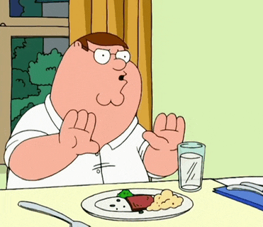 peter griffin from family guy is sitting at a table with a plate of food and a glass of milk