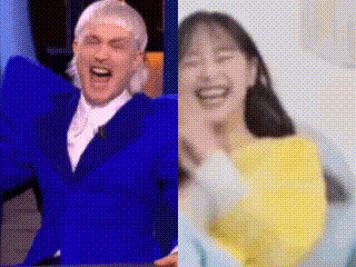 a man in a blue suit and a woman in a yellow sweater are laughing together .