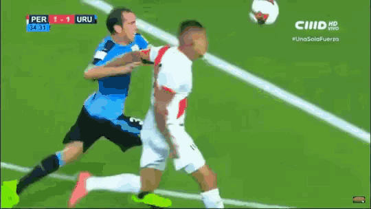 a soccer goalie leaps to catch a ball during a match between peru and uru