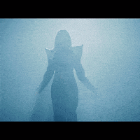a silhouette of a woman in a costume is visible in the fog