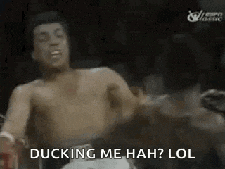 a man without a shirt is fighting another man in a boxing ring and saying `` ducking me hah lol '' .