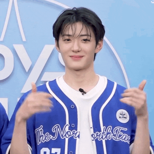 a young man wearing a blue and white jersey that says the north east