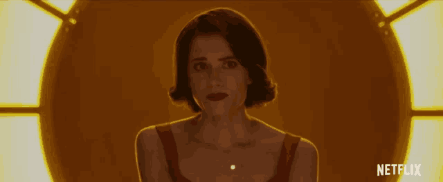 a woman in a red dress with netflix written on the bottom right