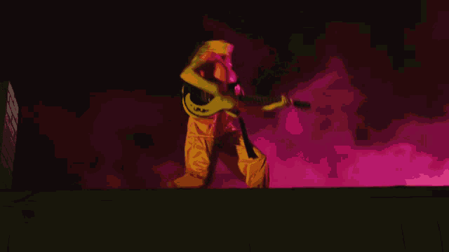 a person in a yellow outfit is playing a guitar in front of a pink background