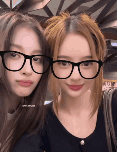 two girls wearing glasses are posing for a picture and one of them has the hashtag @the benyapa