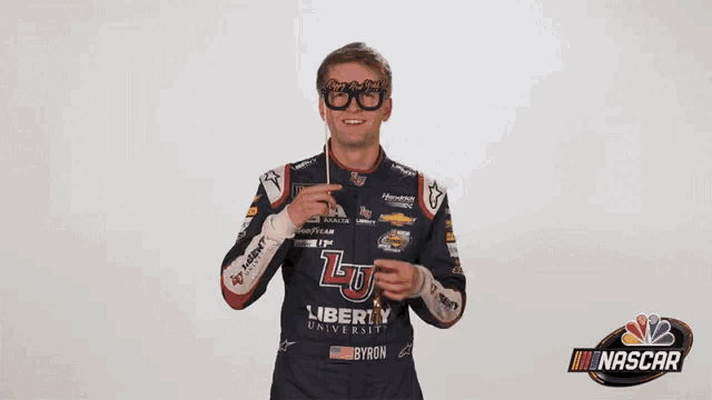 a man wearing a liberty university jersey holds a stick