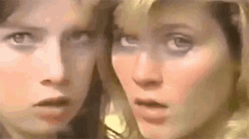 a close up of two women 's faces with their mouths open .