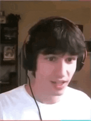 a man wearing headphones and a white shirt is making a funny face .