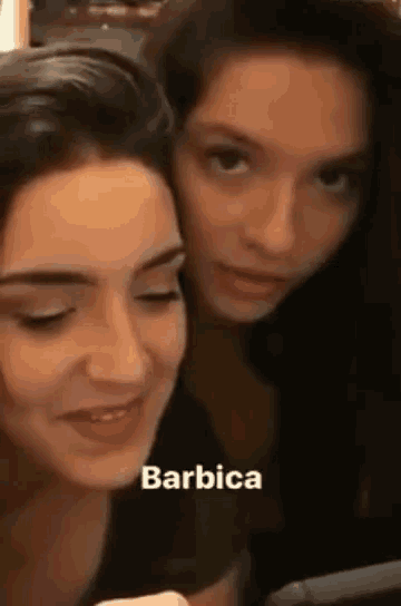 two women are standing next to each other and the word barbica is on the bottom of the picture .